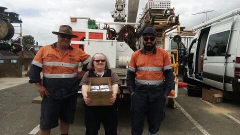 Barb giving muesli bars to SA Power Networks in Kangaroo Island after the fires.